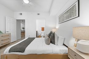 Miramar apartment for rent - A bedroom with a large bed and a ceiling fan.