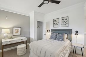 Atlanta apartment for rent - A bedroom with a bed, nightstand, and a ceiling fan.