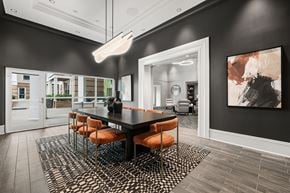 Alexandria apartment for rent - A modern dining room with a black table and orange chairs.