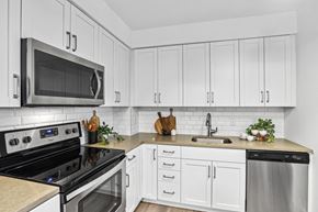 Alexandria apartment for rent - a white kitchen with stainless steel appliances and white cabinets