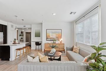 Parker apartment for rent - A living room with a grey couch and a painting on the wall.