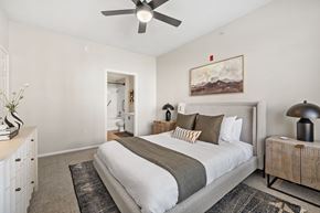 Parker apartment for rent - A bedroom with a large bed and a painting on the wall.