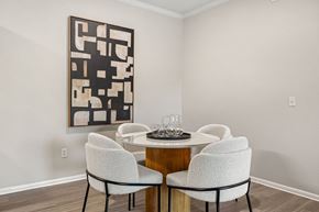 Parker apartment for rent - A dining room with a table and chairs and a large abstract painting on the wall.