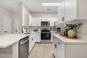 Parker apartment for rent - A modern kitchen with white cabinets and stainless steel appliances.
