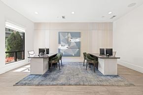 Atlanta apartment for rent - A modern office space with a desk, chairs, and a large window.