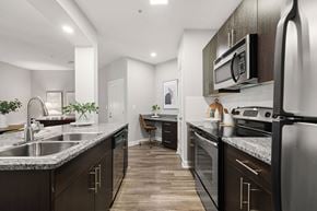 Atlanta apartment for rent - A modern kitchen with dark wood cabinets and stainless steel appliances.