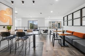 Fort Worth apartment for rent - A modern dining area with black chairs and tables.