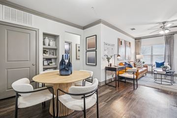 Fort Worth apartment for rent - A modern living room with a round wooden table and chairs.