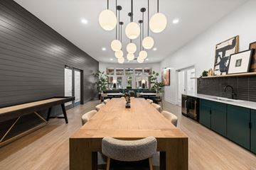 Atlanta apartment for rent - A modern dining room with a long wooden table and chairs.