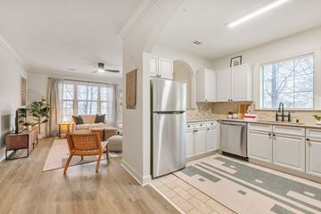 Atlanta apartment for rent - A modern kitchen with white cabinets and a refrigerator.