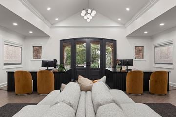 Atlanta apartment for rent - A modern living room with a grey sofa and a black door.
