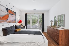 Atlanta apartment for rent - A bedroom with a large bed and a painting on the wall.