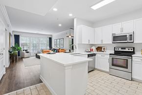 Atlanta apartment for rent - A modern kitchen with white cabinets and a large island.