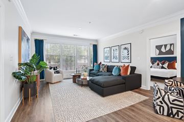 Atlanta apartment for rent - A living room with a black couch and a zebra print chair.