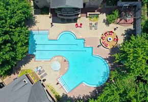 Atlanta apartment for rent - An aerial view of a swimming pool surrounded by trees and a playground.