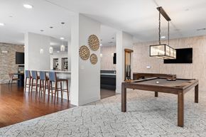Shrewsbury apartment for rent - A pool table is in the middle of a room with a bar and a TV.