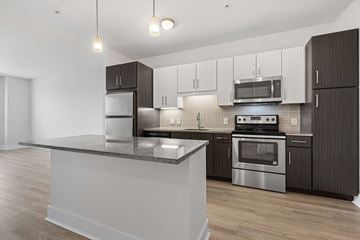 Shrewsbury apartment for rent - A modern kitchen with dark brown cabinets and stainless steel appliances.