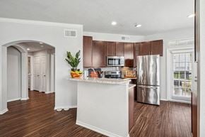 Frisco apartment for rent - a kitchen with a island and a stainless steel refrigerator
