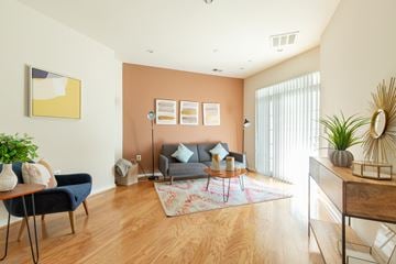 Fairfax apartment for rent - A living room with a blue chair and a grey couch.