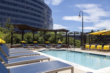 Fairfax apartment for rent - A pool with sun loungers and a building in the background.