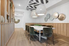 Tampa apartment for rent - A dining room with a white table and green chairs.