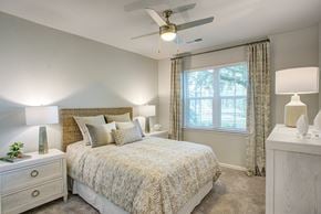 Tampa apartment for rent - a bedroom with a bed and a ceiling fan