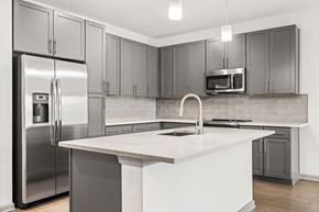 Tampa apartment for rent - A modern kitchen with a stainless steel refrigerator and microwave.