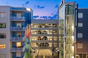 Tampa apartment for rent - Bell Commons is a modern apartment complex with a large parking garage.