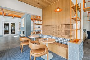 Garner apartment for rent - a lounge area with wooden tables and chairs and a blue tiled floor