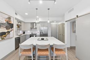 Boca Raton apartment for rent - A modern kitchen with a white table and chairs.