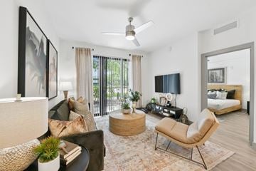 Boca Raton apartment for rent - A living room with a brown chair and a white couch.