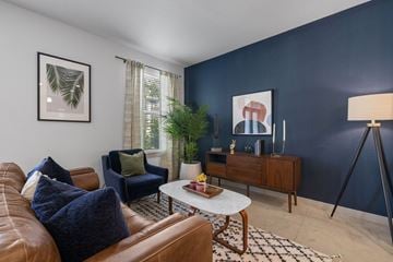 Austin apartment for rent - A living room with a brown leather couch and a white coffee table.