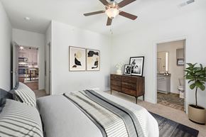 Greensboro apartment for rent - a bedroom with a bed and a ceiling fan
