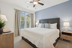 Wilmington apartment for rent - a bedroom with a large bed and a ceiling fan