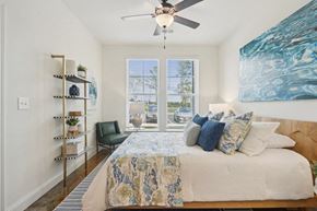 Sneads Ferry apartment for rent - a bedroom with a bed and a ceiling fan