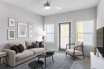 Jacksonville apartment for rent - a living room with a couch and a chair and a window