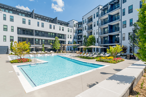 Alpharetta apartment for rent - A swimming pool in front of apartment buildings.
