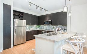 Charleston apartment for rent - a kitchen with a large island and a stainless steel refrigerator