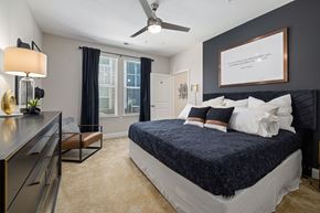 Mooresville apartment for rent - a bedroom with a bed and a ceiling fan