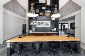 Mooresville apartment for rent - clubhouse entrance with a wooden table and black chairs