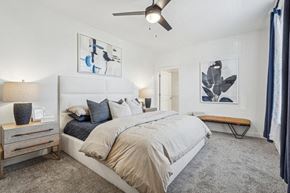 China Grove apartment for rent - A bedroom with a large bed and a ceiling fan.