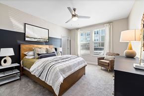 Garner apartment for rent - a bedroom with a bed and a ceiling fan