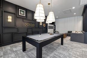 Garner apartment for rent - a billiards table in a game room with three lamps