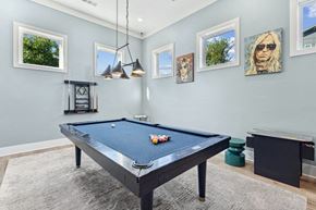 Holly Springs apartment for rent - the pool table in the game room of a modern home