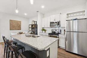 Holly Springs apartment for rent - a kitchen with a marble counter top and stainless steel appliances
