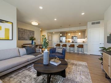 Longmont apartment for rent - a living room with a couch and a table in front of a kitchen