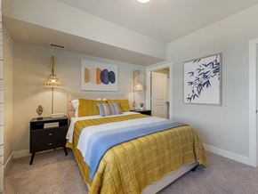 Longmont apartment for rent - A bedroom with a bed, nightstand, and artwork on the wall.