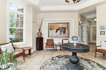 Mooresville apartment for rent - A living room with a large painting of a moose on the wall.