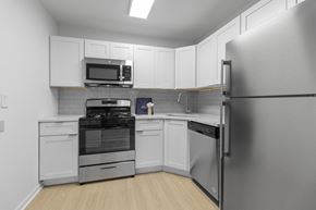 Rockville apartment for rent - a kitchen with stainless steel appliances and white cabinets