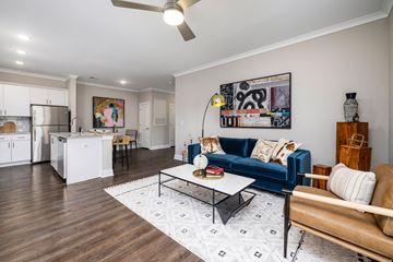 Raleigh apartment for rent - A living room with a blue couch and a coffee table.